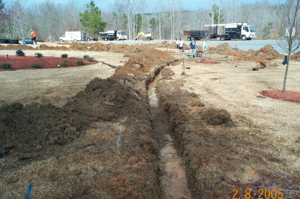 Comprehensive drainage solution with catch basins and corrugated pipe at a Lake Oconee home
