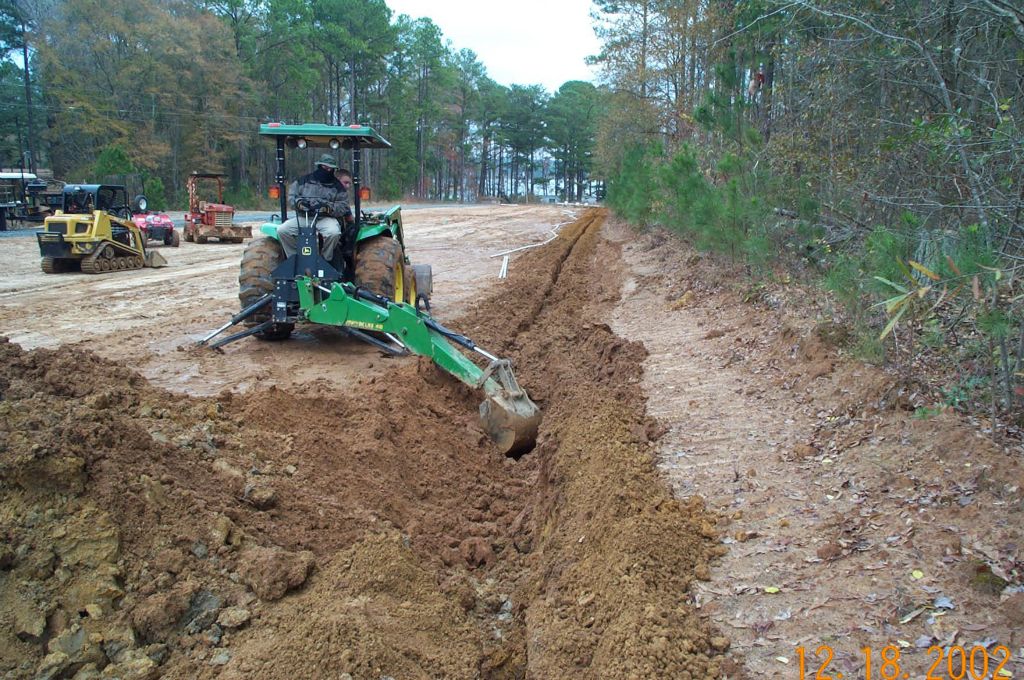 Heavy equipment performing land grading and site preparation for new construction near Lake Sinclair