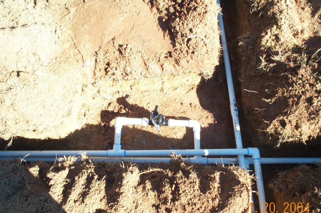 Close-up of a professionally installed irrigation zone valve and manifold assembly