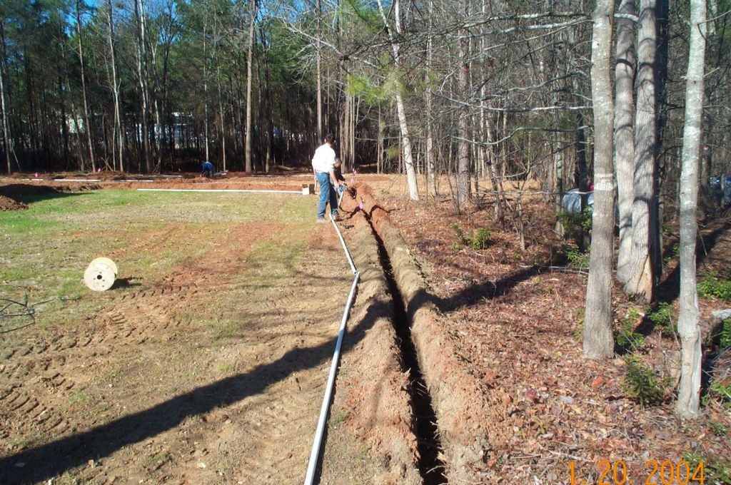 Pop-up sprinkler head watering a freshly sodded lawn near Lake Oconee